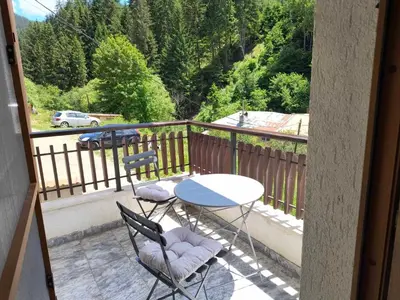 a balcony with a table and two chairs and a table at Апартамент за гости Александър in Chepelare