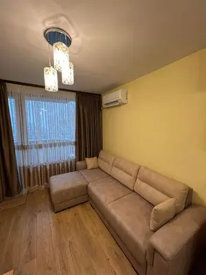 a living room with a couch and a window at New & Stylish Apartment Axel with Mountain Views in Smolyan