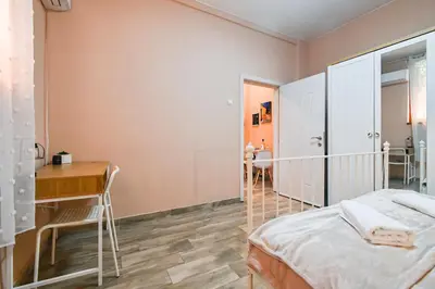 a bedroom with a bed and a desk and a table at Central 47 in Sofia