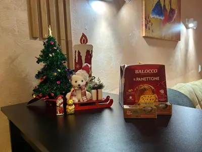 a small christmas tree and a teddy bear on a table at 2-bedroom, 2-bathroom with fireplace and garden at Winslow Infinity in Bansko