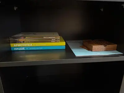 two books sitting on top of a table at 2-bedroom, 2-bathroom with fireplace and garden at Winslow Infinity in Bansko