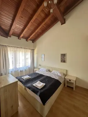 a bedroom with a bed with two towels on it at Pirin Golf Mountain View Apartment in Razlog