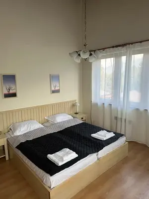a bedroom with a large bed with two towels on it at Pirin Golf Mountain View Apartment in Razlog