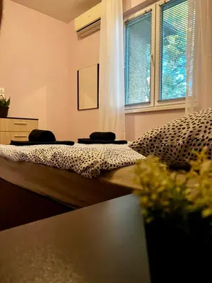 a bedroom with a bed with a leopard print blanket at Cute and Cozy Flat in Sofia