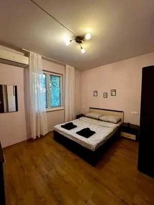 a bedroom with a bed and a ceiling fan at Cute and Cozy Flat in Sofia