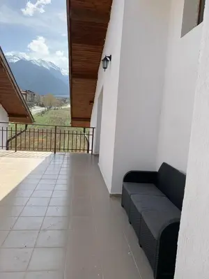 a balcony with a couch and a view of a mountain at Mountain View in Razlog