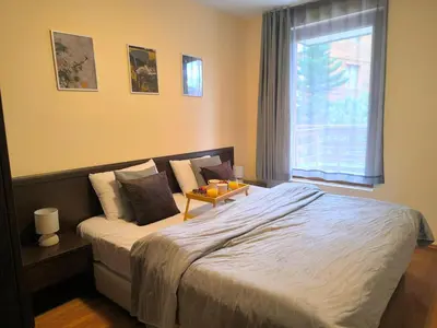 a bedroom with a large bed and a window at Mountain Heaven Retreat with free Bottle of Wine close to Gondola, free Parking in Bansko
