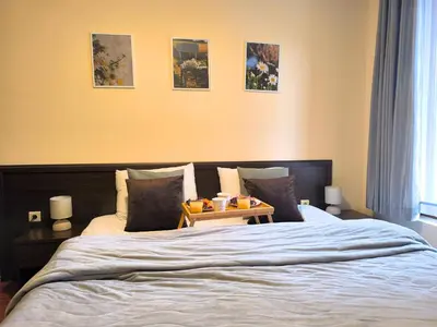 a bedroom with a bed with a tray of food on it at Mountain Heaven Retreat with free Bottle of Wine close to Gondola, free Parking in Bansko