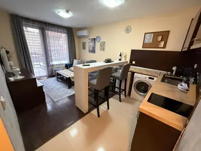 a kitchen and living room with a table and chairs at Mountain Heaven Retreat with free Bottle of Wine close to Gondola, free Parking in Bansko