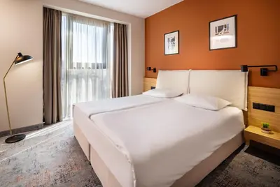 a bedroom with a large white bed and a window at B1 Downtown Hotel, Sofia in Sofia