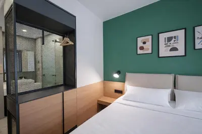 a bedroom with a bed and a blue wall at B1 Downtown Hotel, Sofia in Sofia