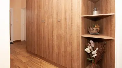 a room with a wooden wall with a vase of flowers at Elevated Living in Sofia