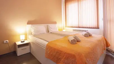 a small bedroom with a bed with towels on it at Elevated Living in Sofia