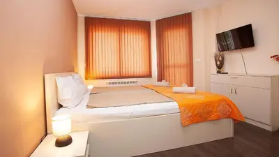 a small bedroom with a bed and a window at Elevated Living in Sofia