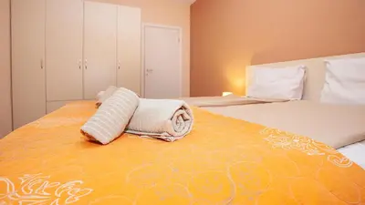 a bedroom with a large bed with an orange at Elevated Living in Sofia