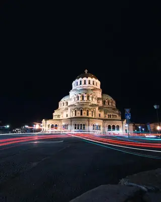 a building at night with a street in front of it at Borisova Garden Skyline by Cosher in Sofia