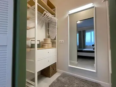 a dressing room with a mirror and a white dresser at Borisova Garden Skyline by Cosher in Sofia