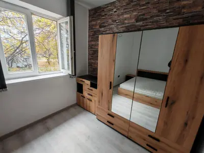 a bedroom with a large wooden cabinet with a bed in it at Apartment 59 in Sofia