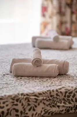 a group of three towels sitting on a bed at Boho Apartment Plovdiv with Private Parking Space in Plovdiv