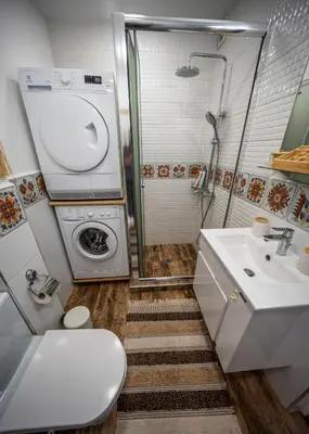 a bathroom with a sink and a washing machine at Boho Apartment Plovdiv with Private Parking Space in Plovdiv