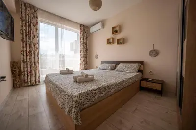 a bedroom with a bed with two stuffed animals on it at Boho Apartment Plovdiv with Private Parking Space in Plovdiv