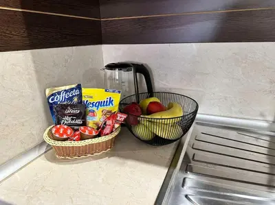 a basket of fruit and snacks on a kitchen counter at Pirin Sky in Bansko