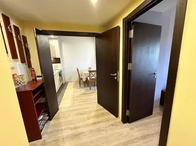 a hallway with a door open to a dining room at Pirin Sky in Bansko