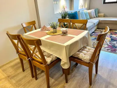 a dining room table with chairs and a couch at Pirin Sky in Bansko