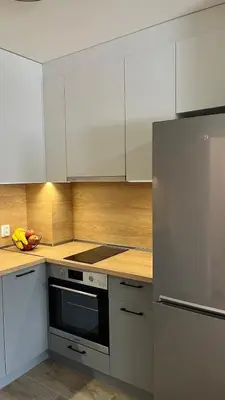 a kitchen with white cabinets and a stainless steel refrigerator at Paradise Park Apartment Central Sofia Gem in Sofia