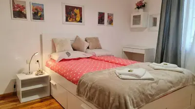a bedroom with a bed with a red polka dot sheets at The Red Sofa City Retreat in Sofia