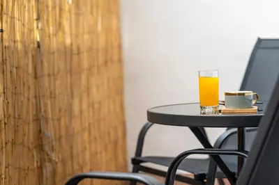 a glass of orange juice sitting on a table at The Red Sofa City Retreat in Sofia