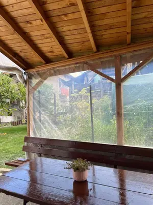 a wooden table with a potted plant sitting on top of a window at Къща за гости Кралимаркови Guest house Kralimarkovi in Devin