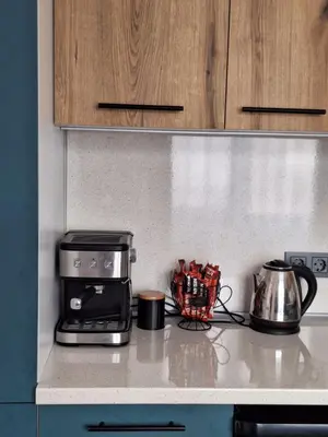 a kitchen counter with a toaster and a coffee maker at Къщи за гости 