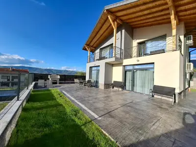 a house with a patio and a balcony at Къщи за гости 