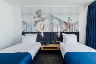 two beds in a room with blue and white at Blue Star Luxury Hotel in Sofia