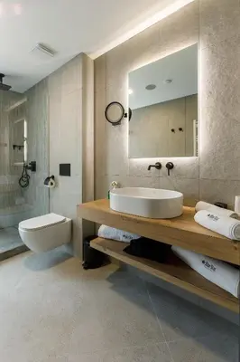 a bathroom with a sink and a toilet and a mirror at Blue Star Luxury Hotel in Sofia