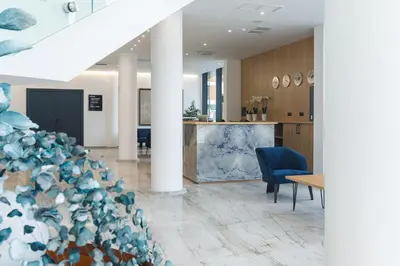an office lobby with blue chairs and a table at Blue Star Luxury Hotel in Sofia