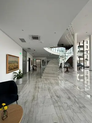 a lobby with a staircase in a building at Blue Star Luxury Hotel in Sofia
