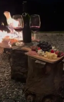 a table with a plate of food and two glasses of wine at Boutique house in Devin