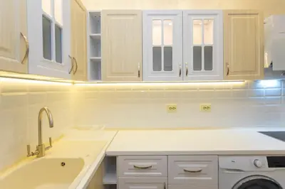 a kitchen with white cabinets and a sink at Central St Vitosha Apartment in Sofia