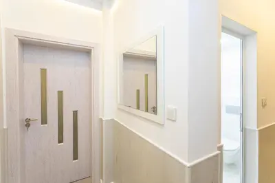 a hallway with a door with a mirror at Central St Vitosha Apartment in Sofia