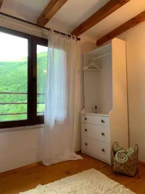 a bedroom with a window with a dresser and a dresser at Beautiful Villa in the Rodopi Mountains in Narechen