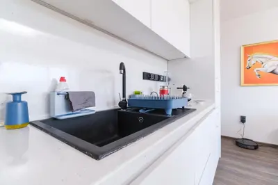 a kitchen with a sink in a white wall at Serene Luxe Oasis Retreat on the Outskirts by Flat Mаnager in Plovdiv