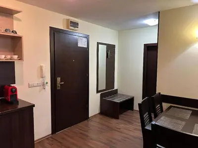 a room with a door and a table and a mirror at Dreamroom Bansko in Bansko
