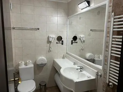 a bathroom with a sink and a toilet and a mirror at Dreamroom Bansko in Bansko