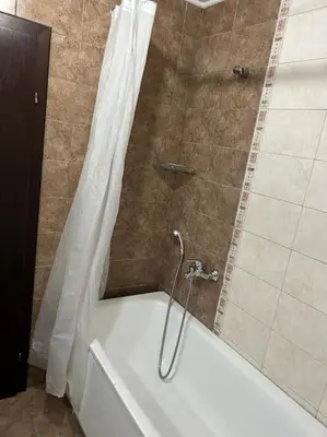 a shower with a white tub with a shower curtain at Dreamroom Bansko in Bansko
