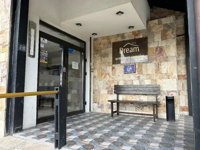 a building with a bench outside of a restaurant at Dreamroom Bansko in Bansko