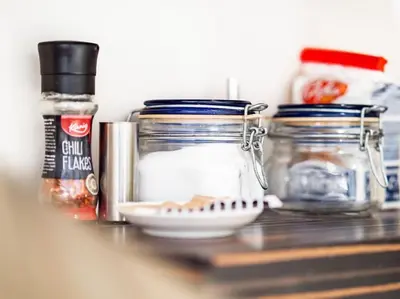 a shelf with jars and other items on a counter at Cozy 1 bdrm, top center, Solunska near Vitoshka street in Sofia