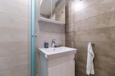 a bathroom with a sink and a shower at Modern 1-Bedroom Apartment with Free Parking in Plovdiv
