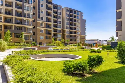 a park in front of a large apartment building at Bright and Cozy 1BD Flat in Plovdiv with Parking by Flat Mаnager in Plovdiv